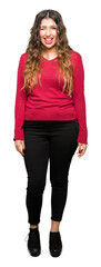 Obraz premium Young beautiful woman wearing red sweater winking looking at the camera with sexy expression, cheerful and happy face.