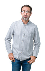 Handsome middle age elegant senior man wearing glasses over isolated background puffing cheeks with funny face. Mouth inflated with air, crazy expression.