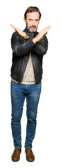 Middle age handsome man wearing black leather jacket Rejection expression crossing arms doing negative sign, angry face