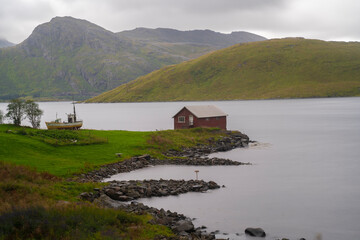 Fototapeta na wymiar lonely cabin next to the sea in the fiords of Lofoten islands, Norway
