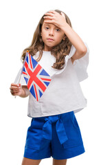 Brunette hispanic girl holding flag of United Kingdom stressed with hand on head, shocked with shame and surprise face, angry and frustrated. Fear and upset for mistake.