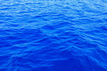 Very nice sea water background or backdrop with selective focus. Small waves of natural water surface texture.