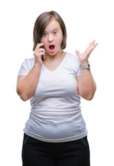 Young adult woman with down syndrome taking using smartphone over isolated background very happy and excited, winner expression celebrating victory screaming with big smile and raised hands