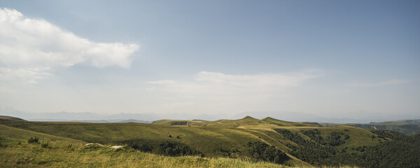 Panorama of a mountain range from the ranges and the pass of the Caucasus Mountains and the ridge, in good sunny summer weather