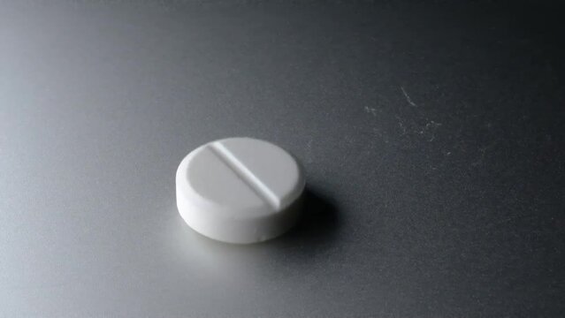 white pills on black background