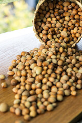 Hazelnuts in a wicker basket on old wooden table