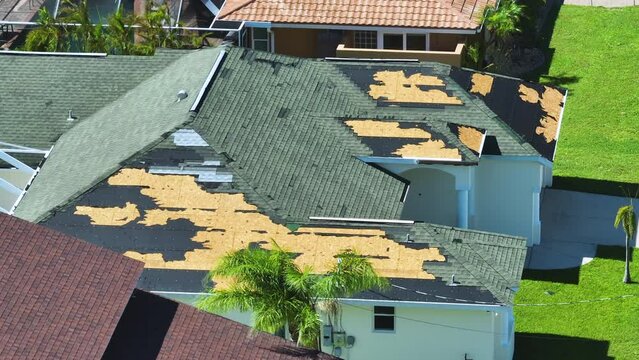 Hurricane Ian destroyed house roof in Florida residential area. Natural disaster and its consequences