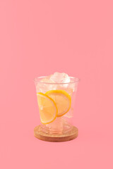 Disposable plastic take away cup with ice cubes on pink background. Serving set for your ice tea or other refreshing drinks. Good kit for street food