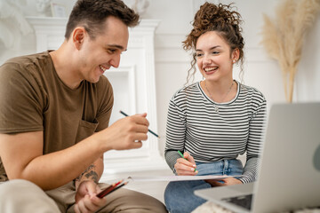 young couple man and woman having online class learn to draw on laptop