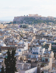 Fototapeta premium Athens, Attica, beautiful super-wide angle view of Athens, Greece, with Acropolis, Mount Lycabettus, mountains and scenery beyond the city, seen from Strefi Hill park in Exarcheia neighbourhood