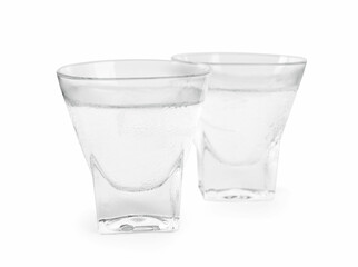 Vodka in shot glasses on white background