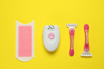 Different epilation products on yellow background, flat lay