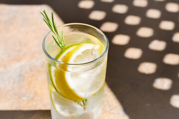 Summer refreshing lemonade on light brown table, closeup