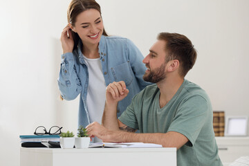 Young couple discussing family budget at home