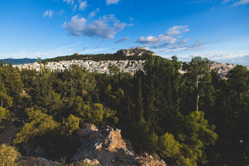 Athens, Attica, beautiful super-wide angle view of Athens, Greece, with Acropolis, Mount Lycabettus, mountains and scenery beyond the city, seen from Strefi Hill park in Exarcheia neighbourhood