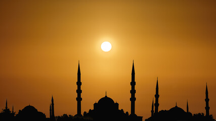  silhouette islamic mosque with domes and towers with background of sunrising