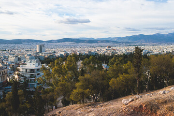 Athens, Attica, beautiful super-wide angle view of Athens, Greece, with Acropolis, Mount Lycabettus, mountains and scenery beyond the city, seen from Strefi Hill park in Exarcheia neighbourhood