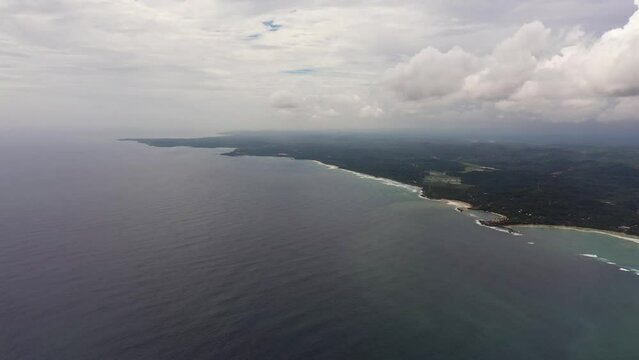 Coast with a beach and hotels among palm trees view from above. Dickwella Beach, Sri Lanka.