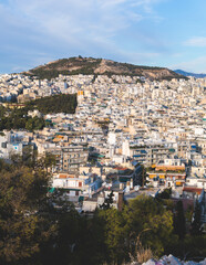 Fototapeta na wymiar Athens, Attica, beautiful super-wide angle view of Athens, Greece, with Acropolis, Mount Lycabettus, mountains and scenery beyond the city, seen from Strefi Hill park in Exarcheia neighbourhood