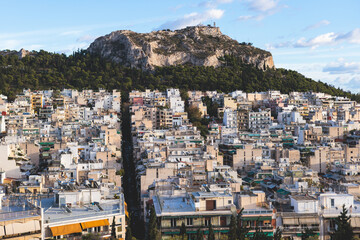 Athens, Attica, beautiful super-wide angle view of Athens, Greece, with Acropolis, Mount Lycabettus, mountains and scenery beyond the city, seen from Strefi Hill park in Exarcheia neighbourhood