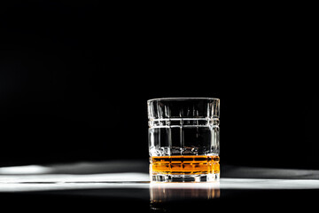 whiskey glass drink with black background on a marble table 