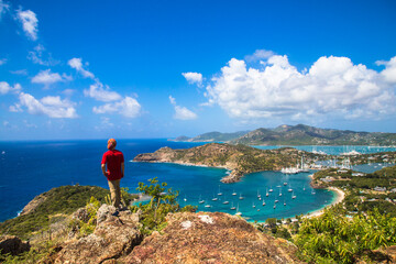 A man standing at Shirley Heights Lookout - A breathtaking and iconic location overlooking English...