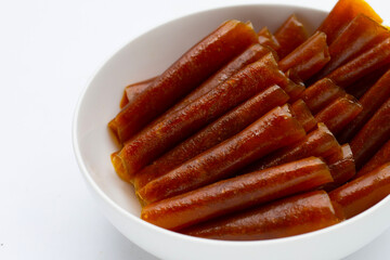Dried mango paste sheets on white background.