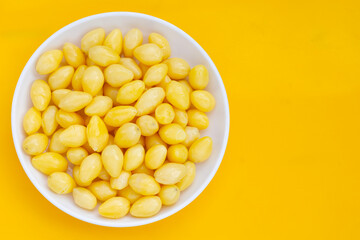 Boiled ginkgo nuts on yellow background.