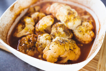 healthy plant-based food, vegan roasted cauliflower in spicy sauce