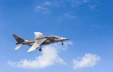 Fototapeta na wymiar Military Fighter Jet on blue sky. Alpha Jet is a high potential fighter.