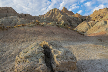 Female Hikers With Eroded Formations Along The Saddle Pass Trail, Badlands National Park, South Dakota, USA