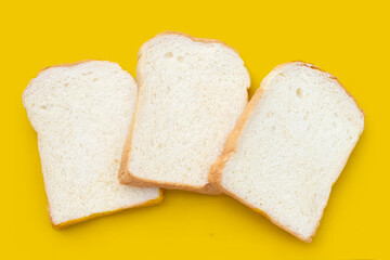 Fototapeta na wymiar Sliced bread on yellow background.