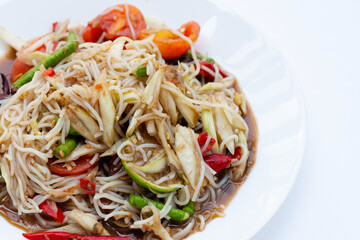 Spicy green papaya salad with vermicelli on white