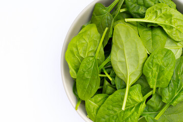 Spinach leaves on white background.