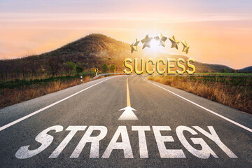  Strategy written on asphalt road in sunset concept of goals and challenges or career path success business opportunity and change.