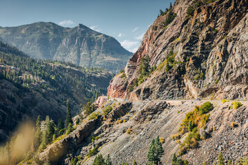 Cars driving on the road through a mountain pass