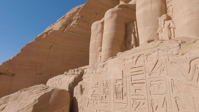 Beautiful hieroglyphs and Ramses statue at Abu Simbel, historic site with two massive rock-cut temples, Egypt