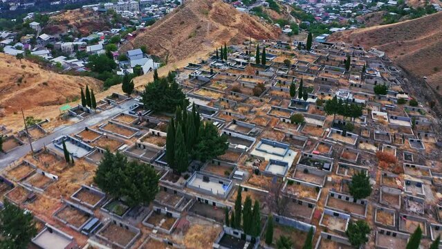Aerial view of city cemetery of Tbilisi on the hill at sunset