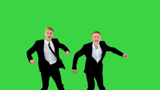 Two easygoing office workers make a funny greeting and start an old school dance on a Green Screen, Chroma Key.