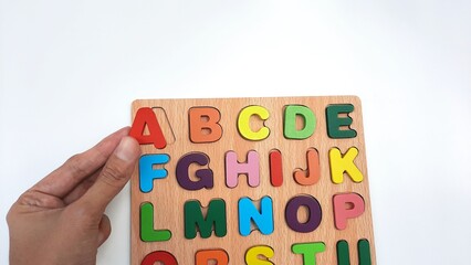 ABC puzzle- Children's alphabet puzzle learning set on isolated white background. Wooden ABC...