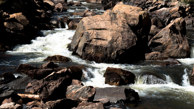 Boulders and rushing water on the Cache La Poudre Wild and Scenic River in Colorado