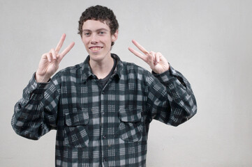 young handsome man posing against grey background