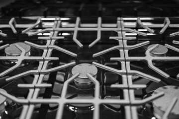 Kitchen surface in stainless steel with cast iron grill. View from above. Stove hob cooking kitchen cooker metal burner