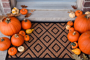 Front porch door mat decorated with pumpkins and gourds
