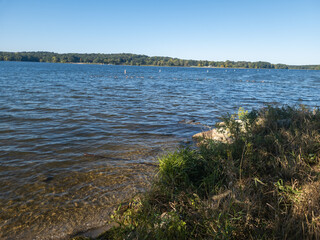 View of the water in Kent Lake in Kensington Metropark near Milford, Michigan. Birds can be seen swimming in the clear waters