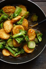  selective focus of stir fry of broccoli and tofu in a spoon 