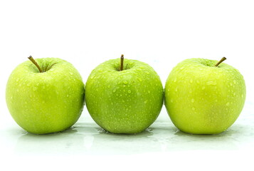 wet green apple on a white background.