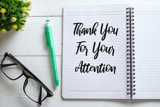Notebook written with Thank You For Your Attention on wooden background
