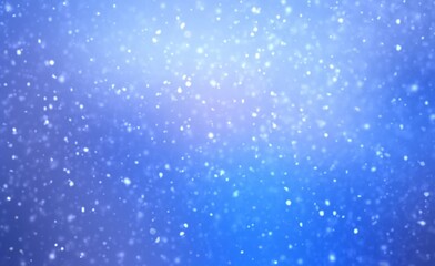 Fluffy snow flakes falls on blue sapphire color empty background. Blur effect. Wonderful winter natural textured backdrop.