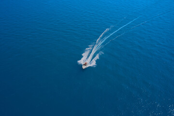 Aerial view luxury motor boat. Top view of a white boat sailing to the blue sea. Travel - image. ...